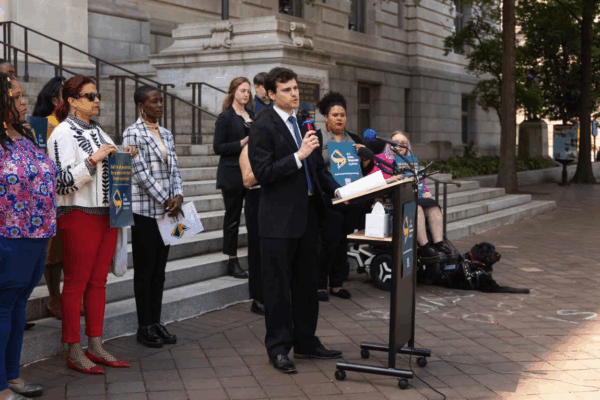 Michael Perloff speaking at the press conference for Crisis Response