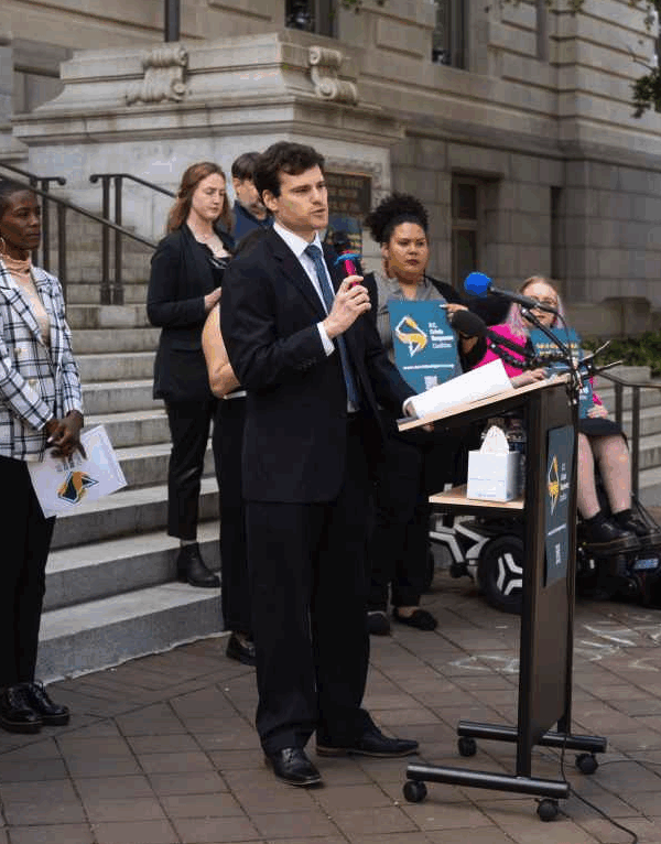 Michael Perloff speaking at the press conference for Crisis Response