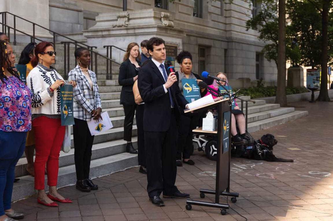 Michael Perloff speaking at the press conference for Crisis Response