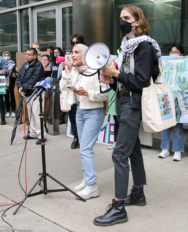 Individuals from Students for Justice in Palestine speak at the Boot Boeing! Free Palestine march and rally while they block all the entrances to Governor Pritzker's Chicago office in downtown Chicago.