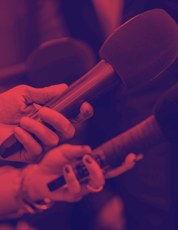 Red and dark blue overlay of hands hold microphones