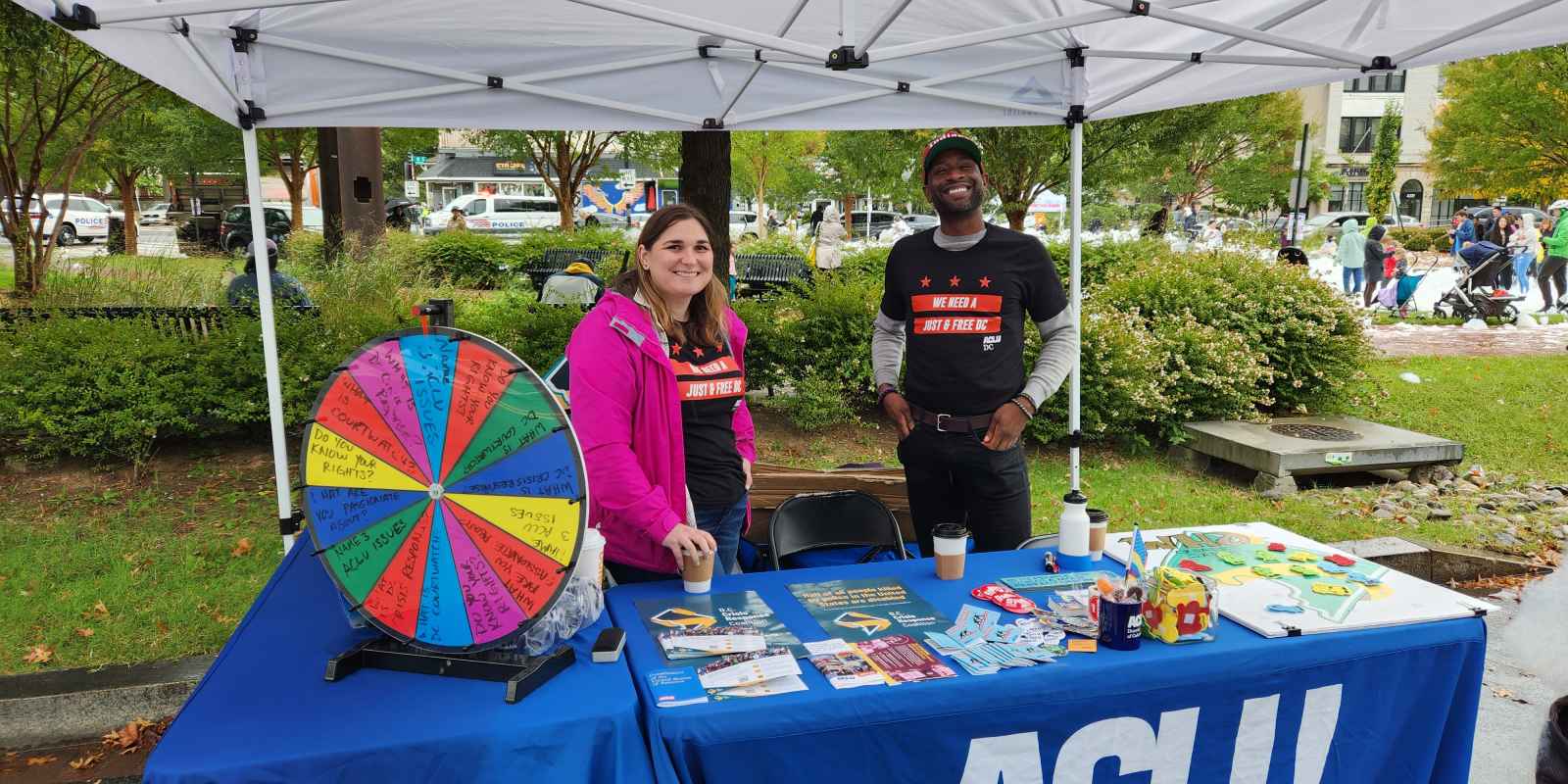 Two ACLU of DC staff members standing at an ACLU booth