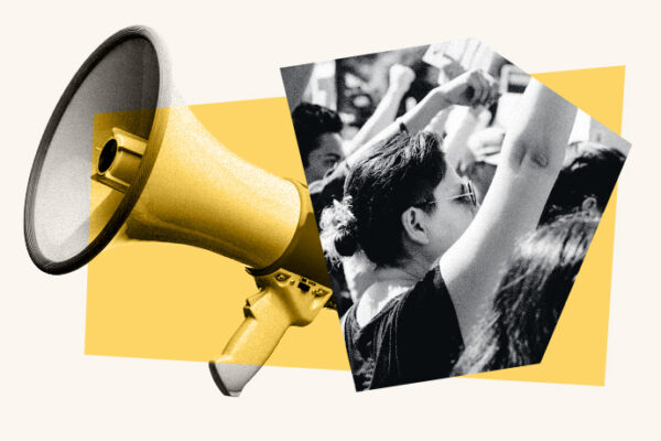 yellow megaphone is positioned on the left side of the image, overlapping a black-and-white photo of a crowd with raised fists, symbolizing protest or activism. The background features abstract yellow geometric shapes.