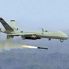 Predator drone shooting a missile against a mountainous background