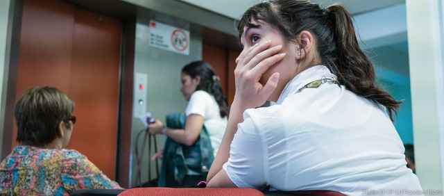 girl waits in doctor waiting room