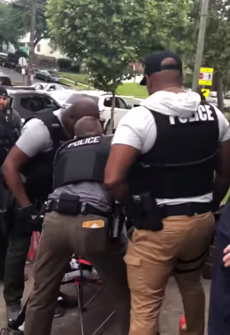 DC Police officers forcibly remove young man from chair