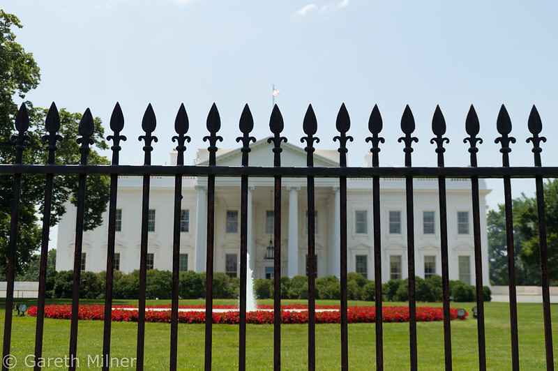 photo of white house through fence